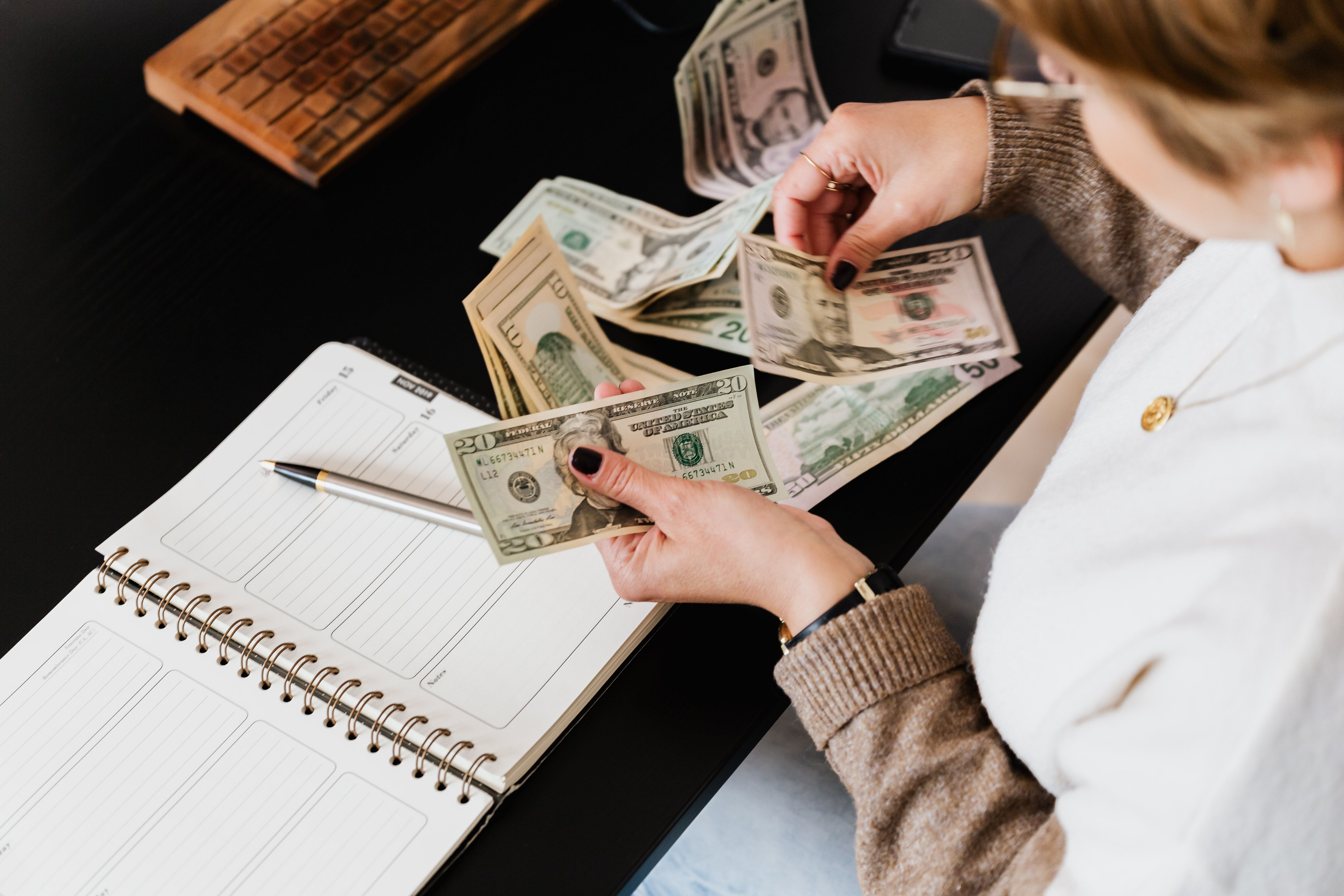Person planning how to reduce monthly expenses and save money